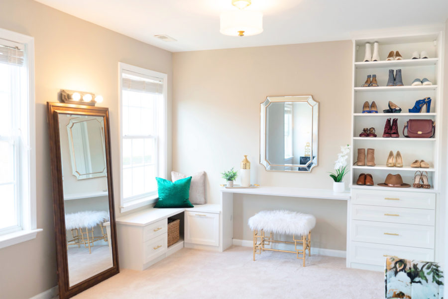 Walk in closet with window and vanity